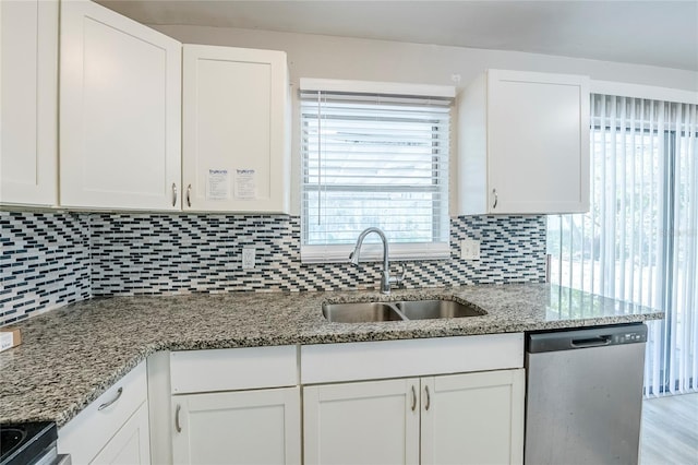 5210 Grandview Dr, Orlando, FL 32808 - kitchen featuring decorative backsplash, white cabinets, dishwasher, and a sink