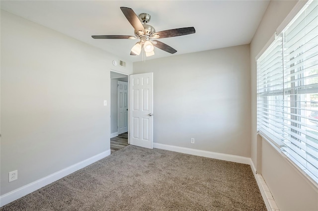 5210 Grandview Dr, Orlando, FL 32808 - unfurnished room featuring light carpet, visible vents, baseboards, and ceiling fan