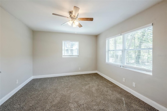 5210 Grandview Dr, Orlando, FL 32808 - carpeted empty room with a healthy amount of sunlight, baseboards, and ceiling fan