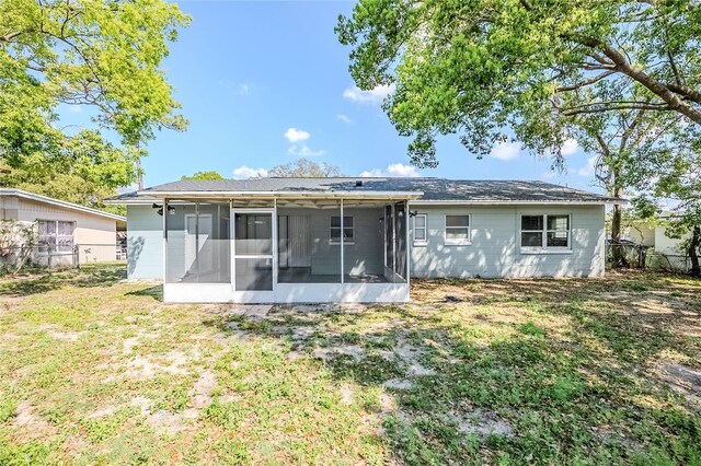 5210 Grandview Dr, Orlando, FL 32808 - rear view of house featuring a sunroom, a yard, and fence