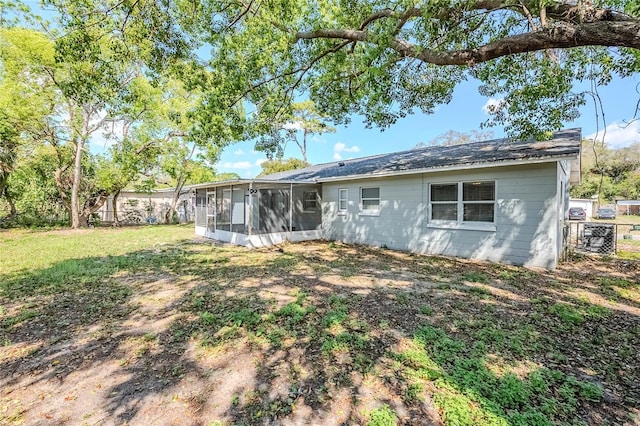 5210 Grandview Dr, Orlando, FL 32808 - rear view of house with concrete block siding, a yard, and a sunroom