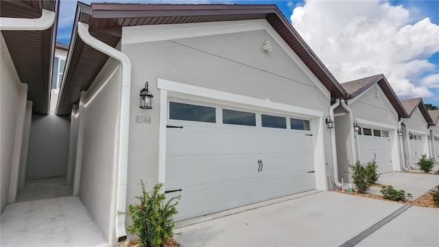 garage featuring concrete driveway