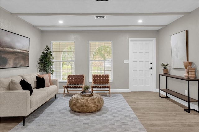 living room with recessed lighting, beamed ceiling, baseboards, and light wood-style flooring