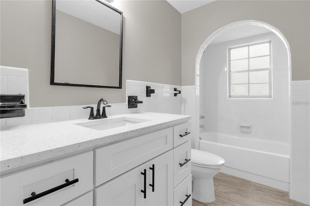 bathroom featuring tub / shower combination, toilet, and vanity