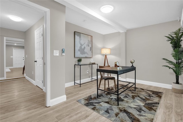 office space featuring baseboards and light wood finished floors