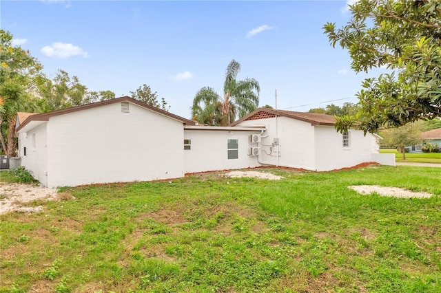 rear view of house with a yard