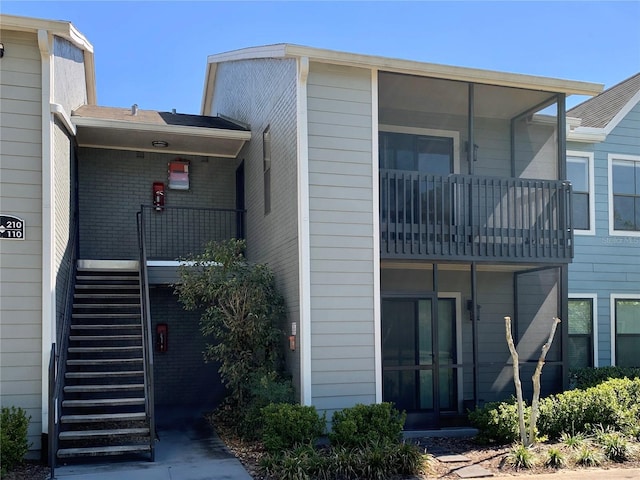 back of property featuring stairway