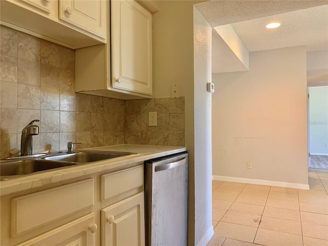 kitchen with a sink, tasteful backsplash, light countertops, light tile patterned floors, and dishwasher