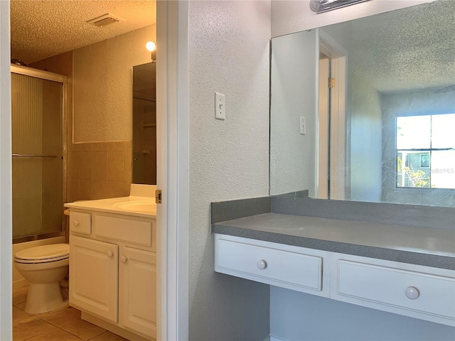 full bathroom featuring tile patterned floors, a textured ceiling, tile walls, vanity, and a textured wall