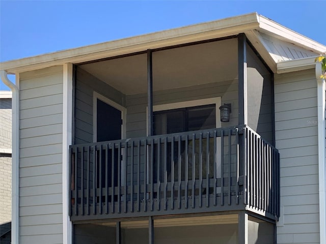 view of exterior entry featuring a balcony