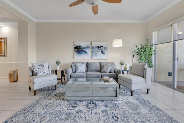 tiled living area featuring a ceiling fan and ornamental molding