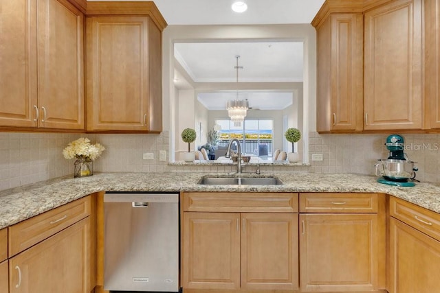 kitchen featuring light stone counters, backsplash, dishwasher, and a sink