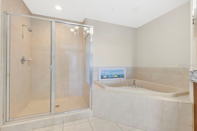 bathroom with tile patterned flooring, a stall shower, and a garden tub