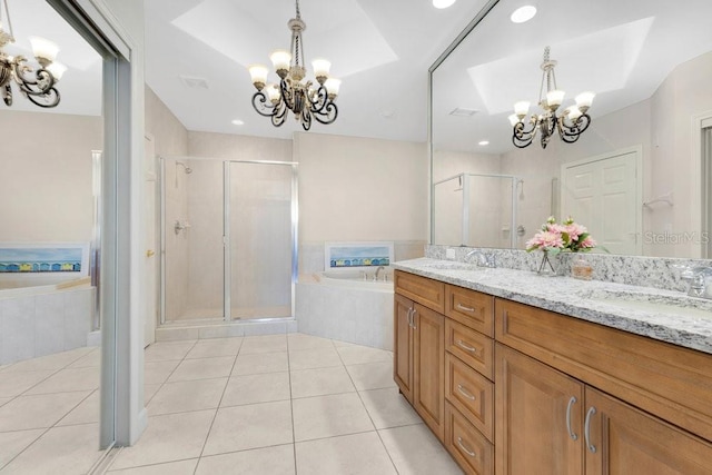 bathroom featuring a sink, an inviting chandelier, a shower stall, and tile patterned flooring