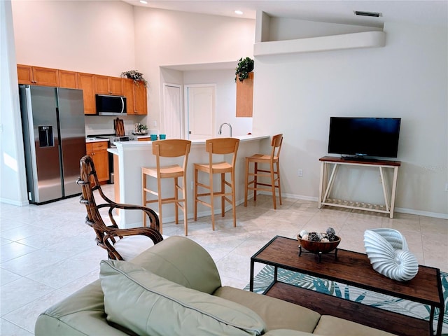 living room with visible vents, baseboards, and light tile patterned flooring