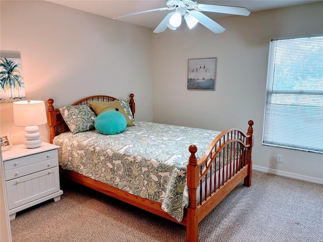 bedroom with a ceiling fan, light colored carpet, and baseboards