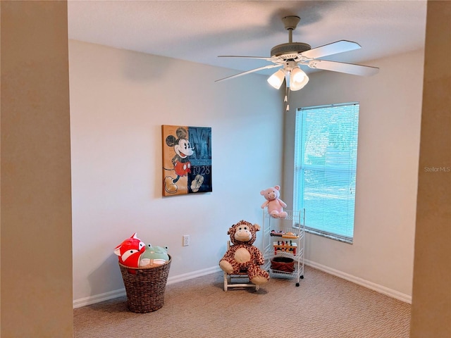 game room with a wealth of natural light, baseboards, ceiling fan, and carpet floors