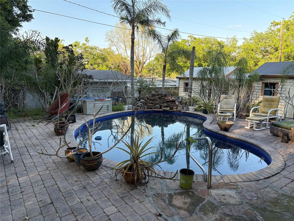 view of swimming pool featuring a patio area, a fenced in pool, and a fenced backyard