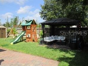 view of play area featuring a lawn