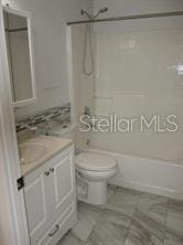 full bath with vanity, toilet, and shower / bath combination