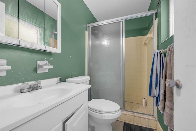 full bathroom with toilet, a stall shower, and vanity