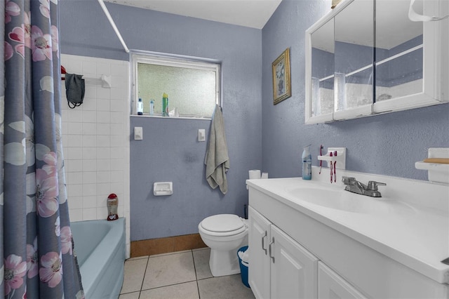 full bath featuring tile patterned floors, baseboards, toilet, and a textured wall