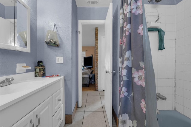 bathroom with vanity, shower / bathtub combination with curtain, visible vents, ensuite bath, and tile patterned floors