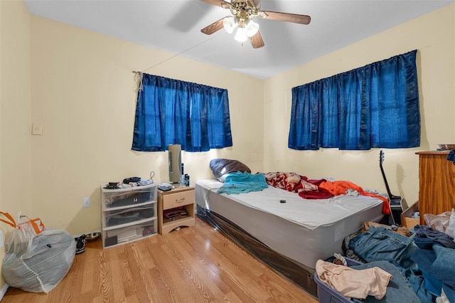 bedroom featuring a ceiling fan and wood finished floors