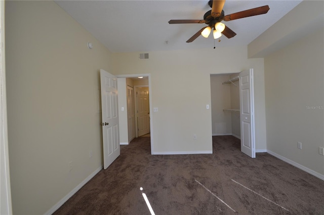 unfurnished bedroom with visible vents, baseboards, a spacious closet, and carpet flooring