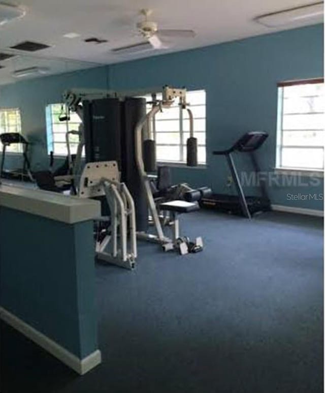 gym featuring plenty of natural light, baseboards, and visible vents