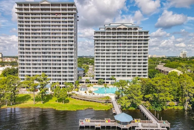 view of building exterior with a city view and a water view