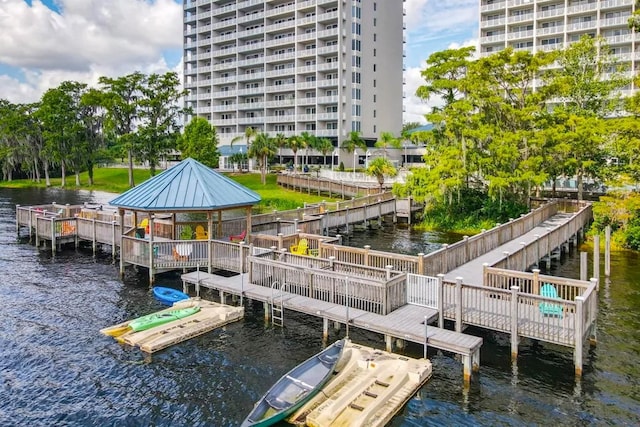 view of dock with a gazebo and a deck with water view