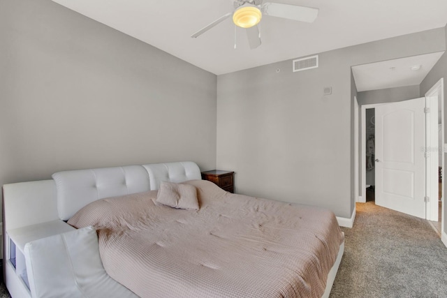 carpeted bedroom featuring a ceiling fan, visible vents, and baseboards