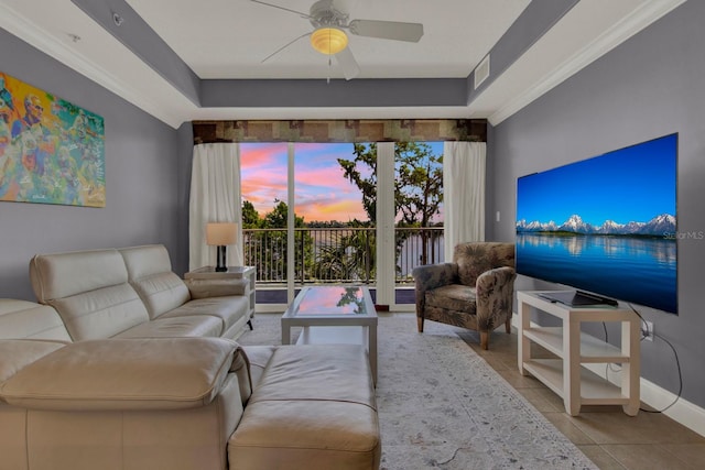 living room featuring visible vents, ornamental molding, tile patterned flooring, baseboards, and ceiling fan