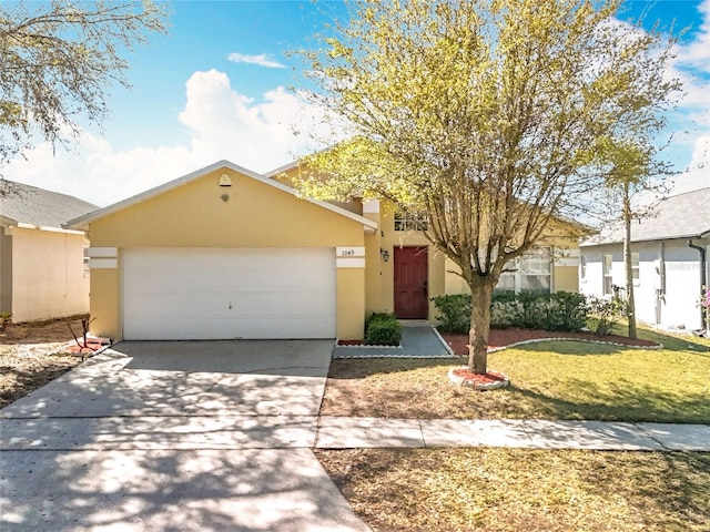 single story home featuring stucco siding, driveway, an attached garage, and a front yard