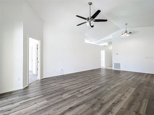 unfurnished living room with ceiling fan with notable chandelier, wood finished floors, visible vents, and a textured ceiling