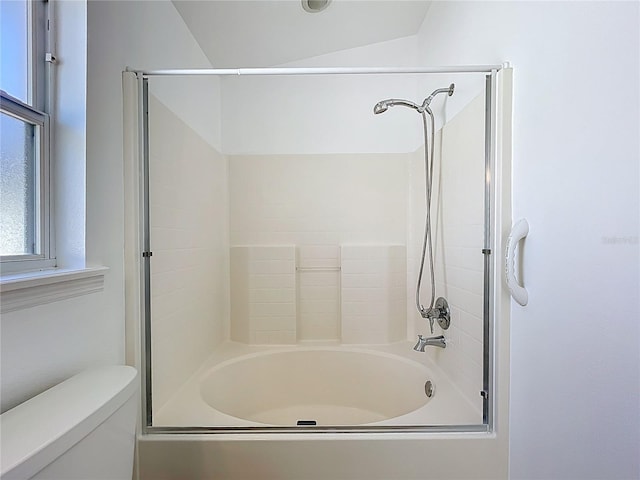 bathroom with  shower combination, toilet, and lofted ceiling