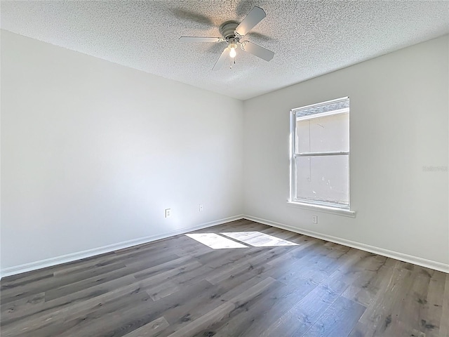 unfurnished room with dark wood finished floors, baseboards, a textured ceiling, and a ceiling fan