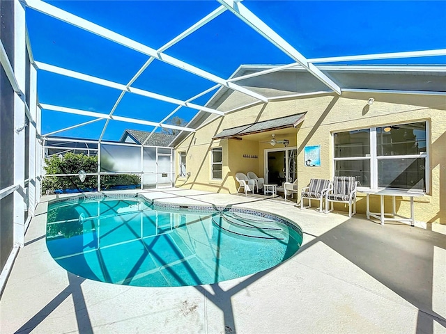 pool with glass enclosure and a patio area