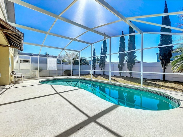 view of pool with a patio, a fenced backyard, a fenced in pool, and a lanai