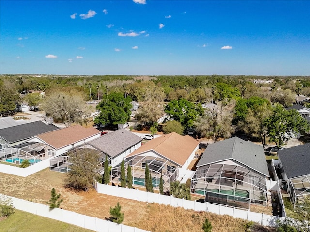 birds eye view of property with a view of trees and a residential view