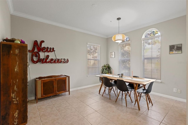 dining area featuring a wealth of natural light, light tile patterned floors, baseboards, and ornamental molding