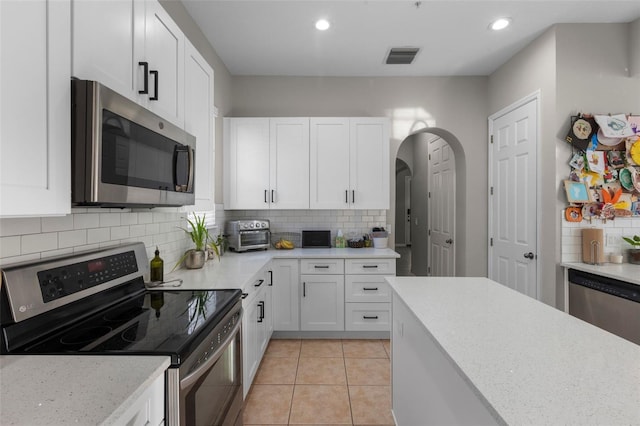 kitchen with white cabinetry, recessed lighting, and stainless steel appliances