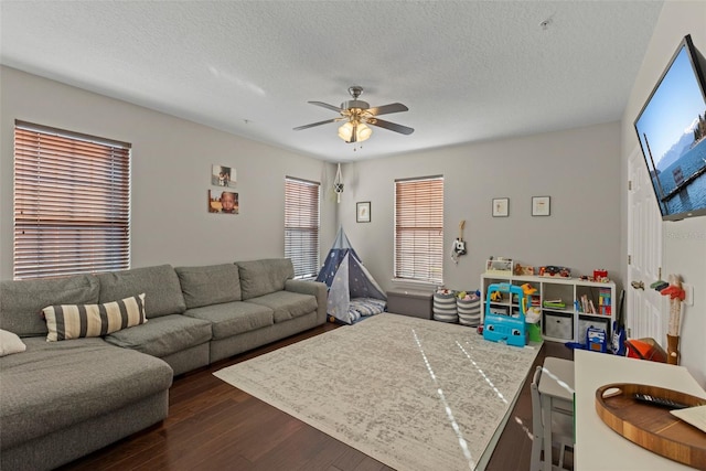 living room with dark wood-style floors, a textured ceiling, and ceiling fan