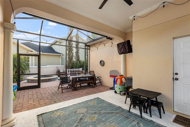 view of patio featuring glass enclosure, an in ground hot tub, outdoor dining area, and ceiling fan