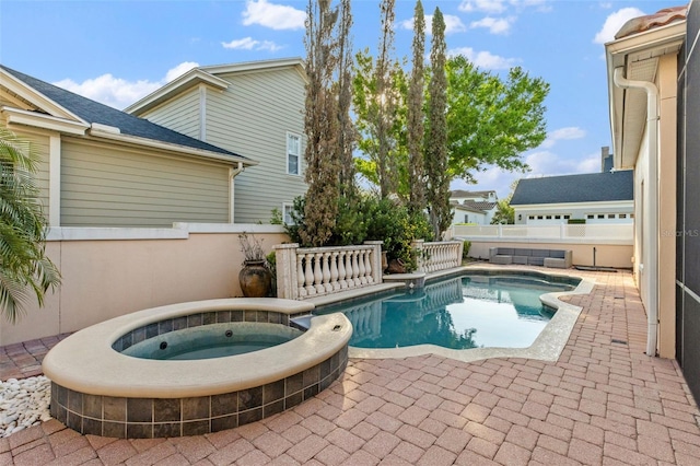 view of swimming pool featuring an in ground hot tub, a fenced backyard, a fenced in pool, and a patio