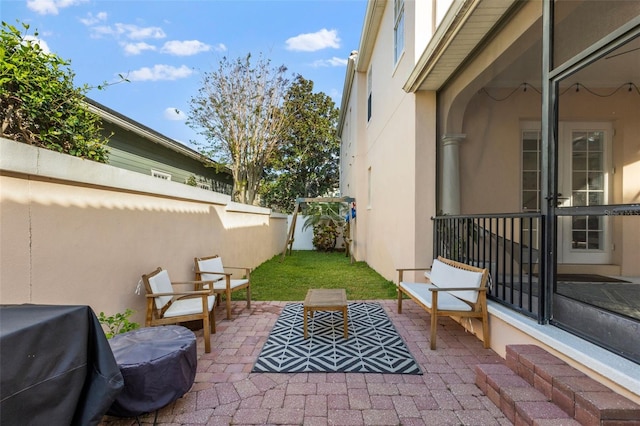 view of patio with area for grilling and fence private yard