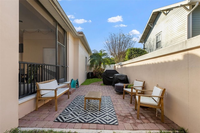 view of patio with an outdoor living space and a fenced backyard