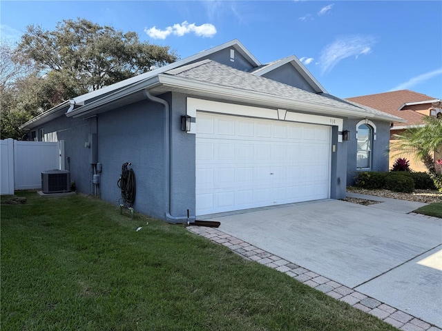 view of side of property with driveway, a yard, stucco siding, a garage, and central air condition unit