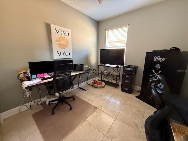 office with light tile patterned floors, baseboards, and a textured ceiling